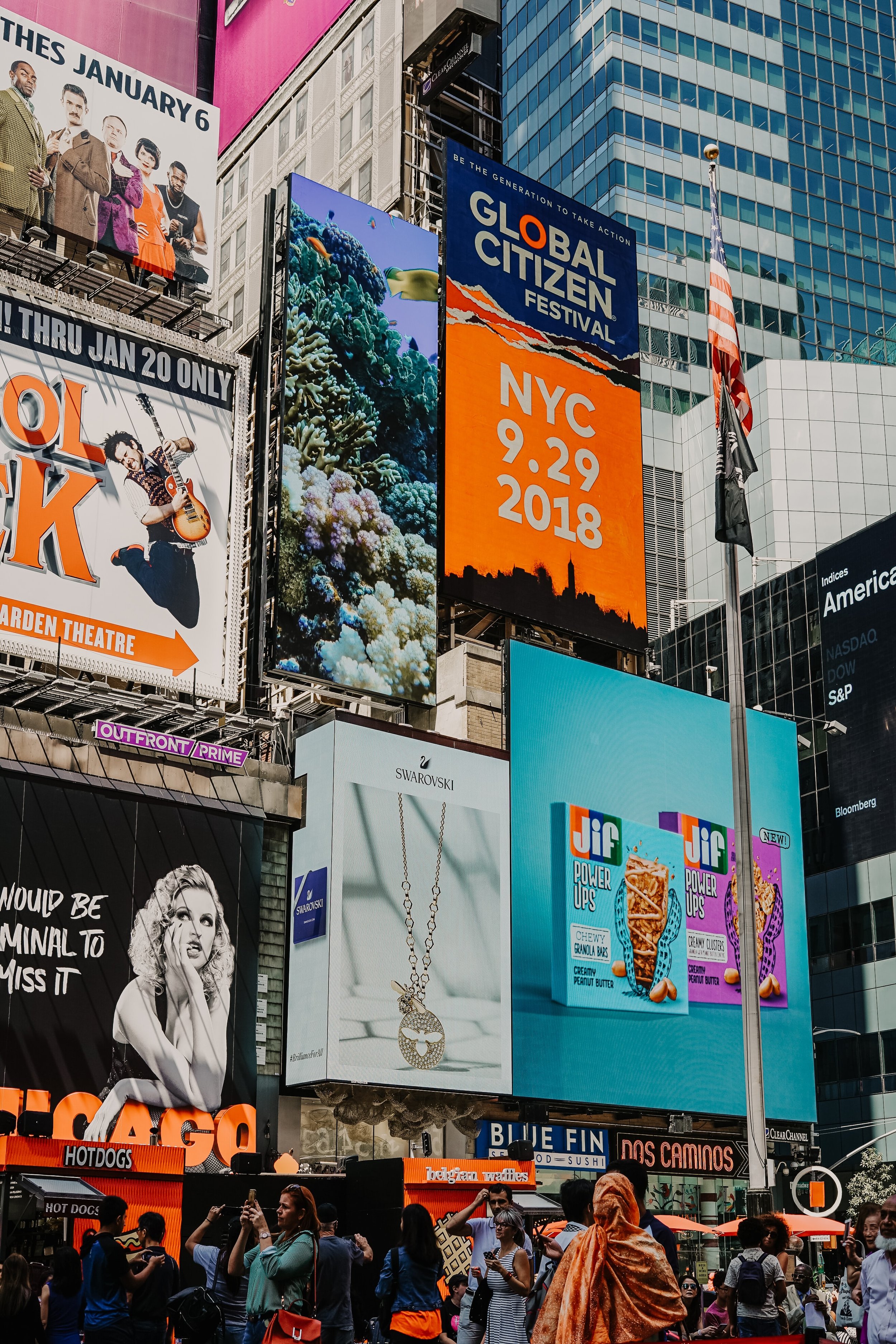 Photo of several billboard advertisements in a square in New York City.